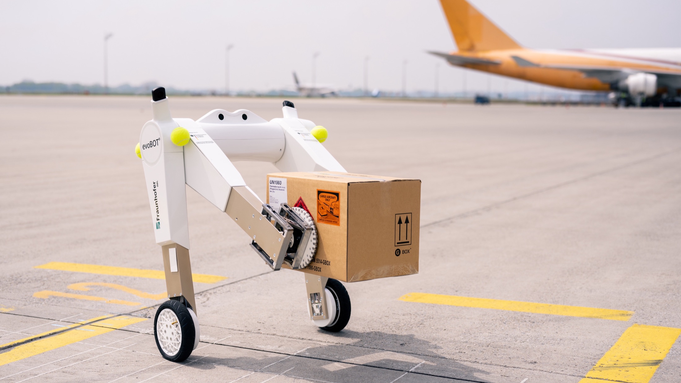 evoBOT transporting an air-cargo package on an airport apron.
